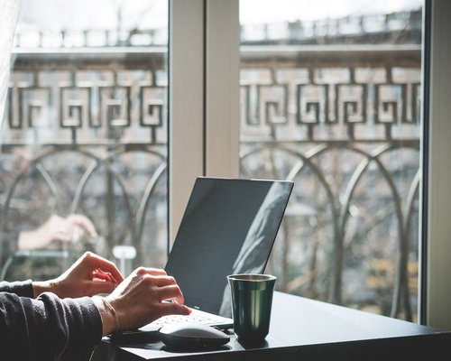 person working on a laptop beside a bright window in Chile